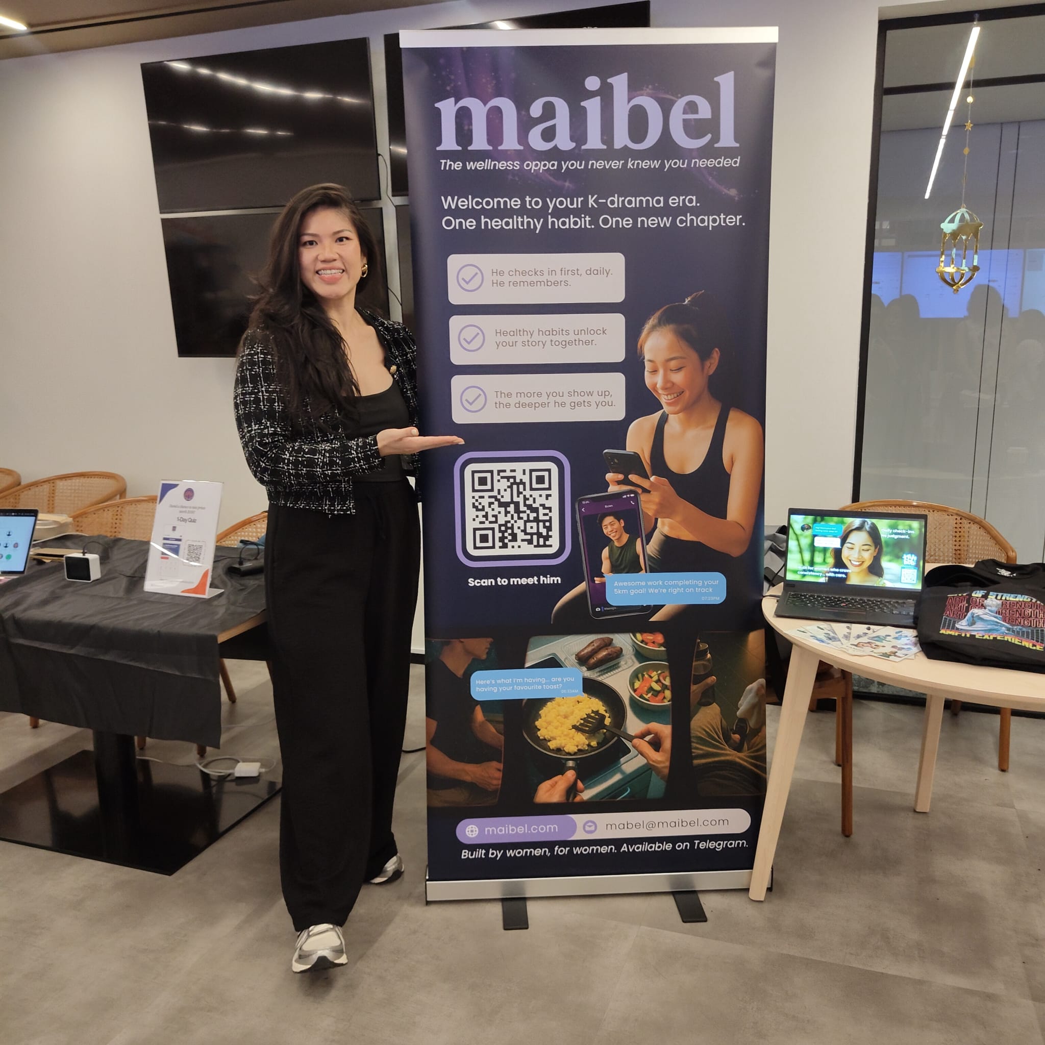Mabel beside Maibel’s wellness companion display at a product showcase